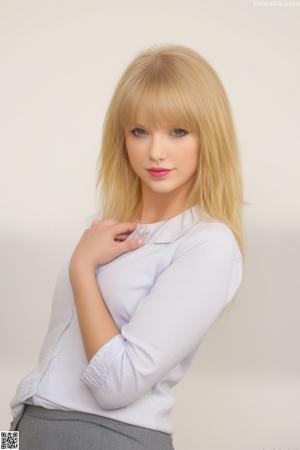 A woman in a gray shirt and blue skirt posing for a picture.