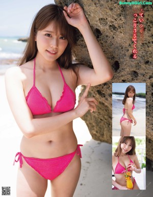 A woman in a pink bikini standing on a beach.