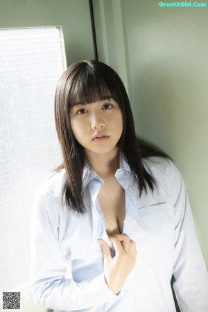 A woman with long black hair wearing a white dress.