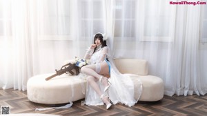 A woman in a white dress posing for a picture.