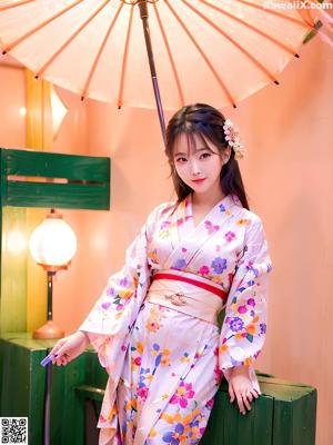 A woman in a kimono standing in front of a building.